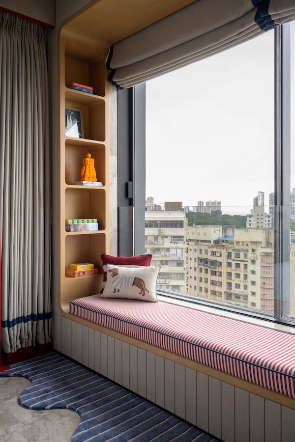 The colossal windows in the home allow views of the cityscape while drenching the space. (Image Credits: Wabi Sabi)