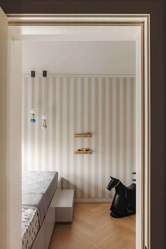 The chic kid’s nursery is perfectly layered with stripes featuring stripped wallpaper from Pride Furnishing Wooden herringbone flooring by Excella Experts. (Image credits: Lokesh Dang)